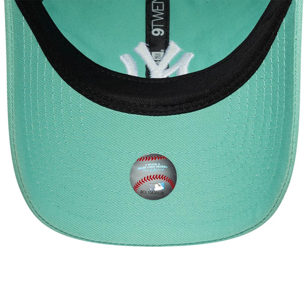 New York Yankees MLB League Essential Pastel Green New Era 9TWENTY Adjustable Cap, inside view showing black taping with the 9TWENTY label, a black sweatband, pastel green undervisor, and a sticker featuring the MLB logo on the inner panel.