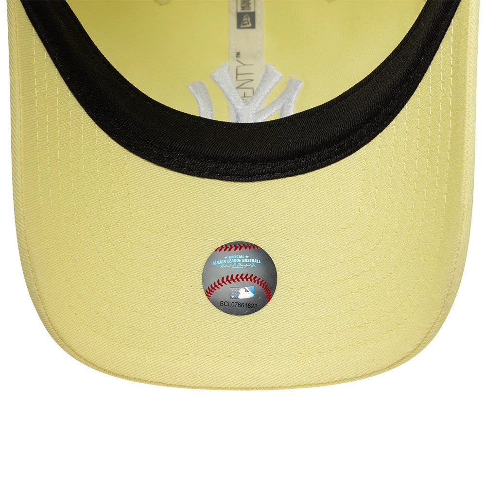 New York Yankees MLB League Essential Pastel Yellow New Era 9TWENTY Adjustable Cap, inside view showing a black sweatband with the MLB holographic sticker on the yellow undervisor next to the grey internal taping and Yankees logo.