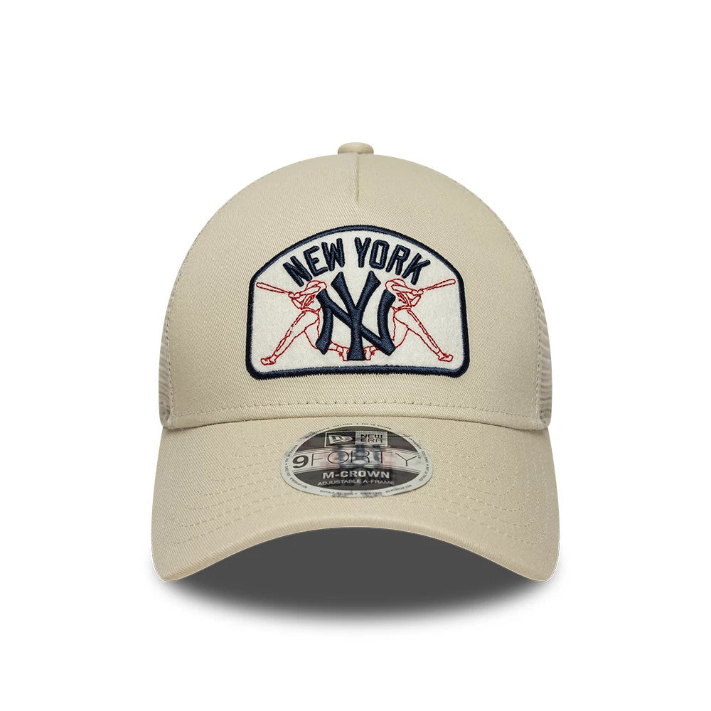 New York Yankees MLB Patch Cream New Era 9FORTY M-Crown A-Frame Trucker Adjustable Cap, front view showing a cream structured crown with a large embroidered New York Yankees logo, crossed baseball bats design.