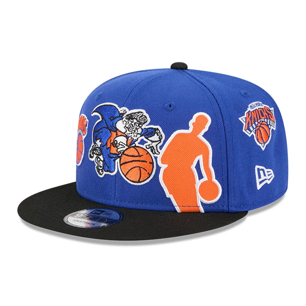 New York Knicks NBA Hardwood Classic ASG Blue New Era 9FIFTY Snapback Adjustable Cap, front view showing a orange and white embroidered Knicks logo on the blue front panel, contrasted with a black flat visor and a 9FIFTY size sticker.