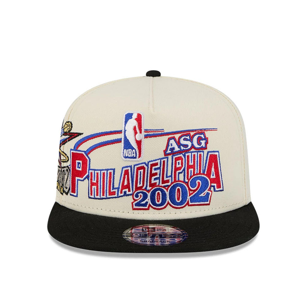 76ers NBA Hardwood Classic ASG White New Era 9FIFTY A-Frame Snapback Cap, front view showing a red and blue embroidered Philadelphia 2002 design with NBA and ASG lettering, on a structured white crown with a black flat visor and size sticker.