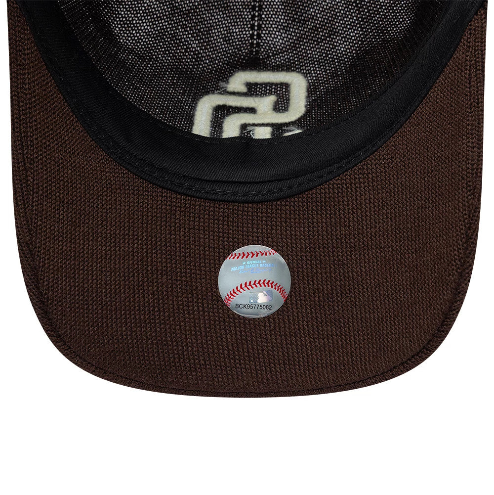 San Diego Padres MLB Core Merino Wool Dark Brown New Era 9TWENTY Adjustable Cap, inside view showing the black sweatband, a white embroidered SD logo on the undervisor, and an MLB baseball sticker with stitching pattern on the visor.