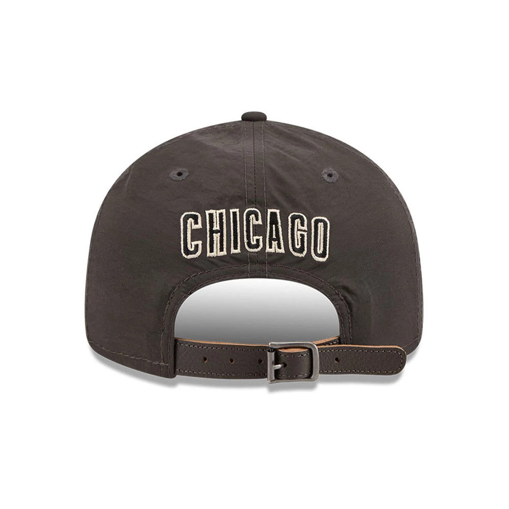 Chicago Cubs MLB Nylon Black Retro Crown New Era 9FIFTY Adjustable Cap, rear view showing the white embroidered Chicago lettering across the back panels, with an opening above the brown adjustable strap and grey eyelets on the black crown.