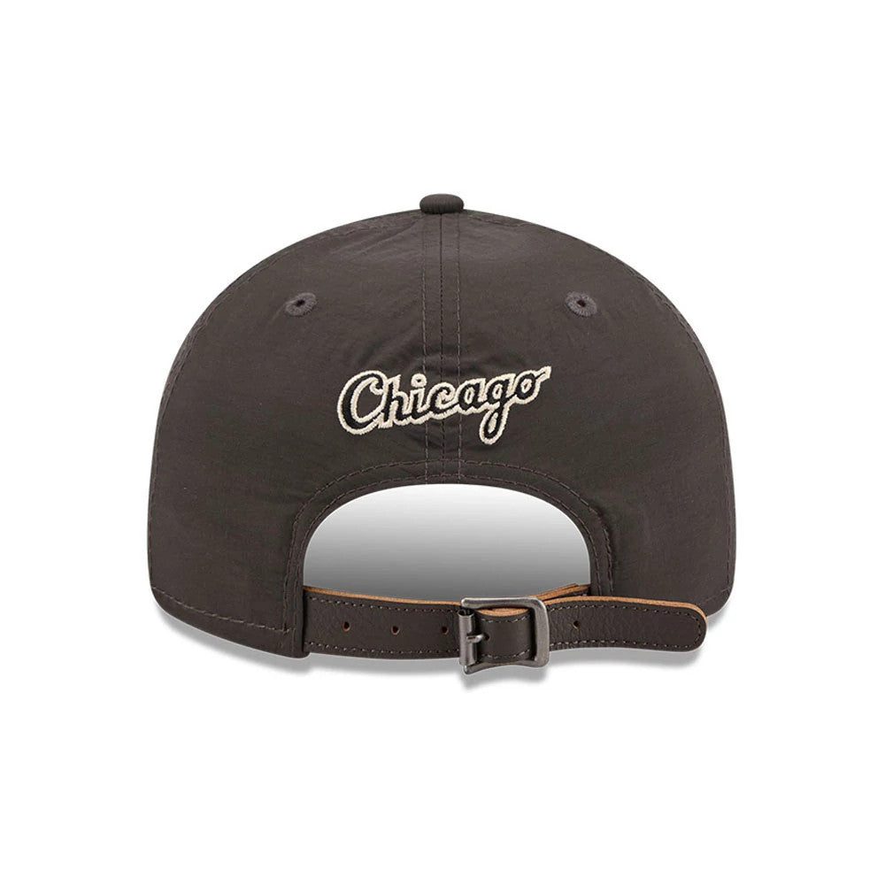 Chicago White Sox MLB Nylon Black Retro Crown New Era 9FIFTY Adjustable Cap, rear view showing the white embroidered Chicago script logo above the arch-shaped opening, with black eyelets and a black adjustable strap with a buckle.