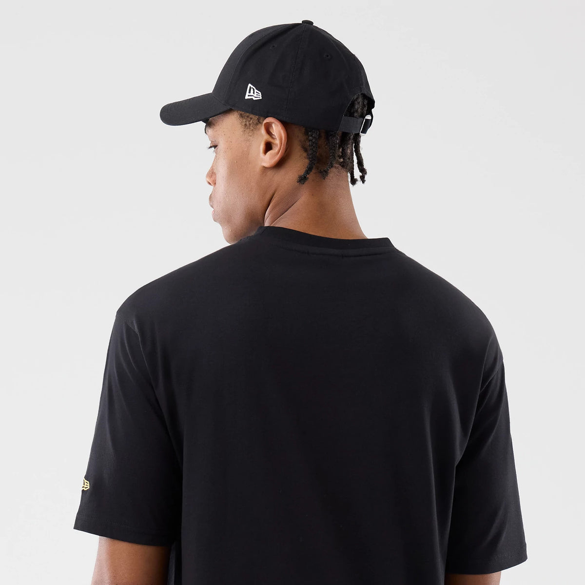 The model is wearing this New Era Sticker Madrid Oversized T-Shirt in black. 7