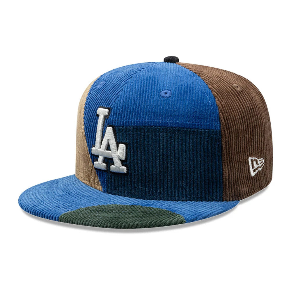 LA Dodgers MLB Patchwork Dark Blue New Era 59FIFTY Fitted Cap, three-quarter view showing the raised white LA logo on a patchwork design with blue, brown, and green corduroy panels, grey New Era flag logo on the left side, and a flat visor.
