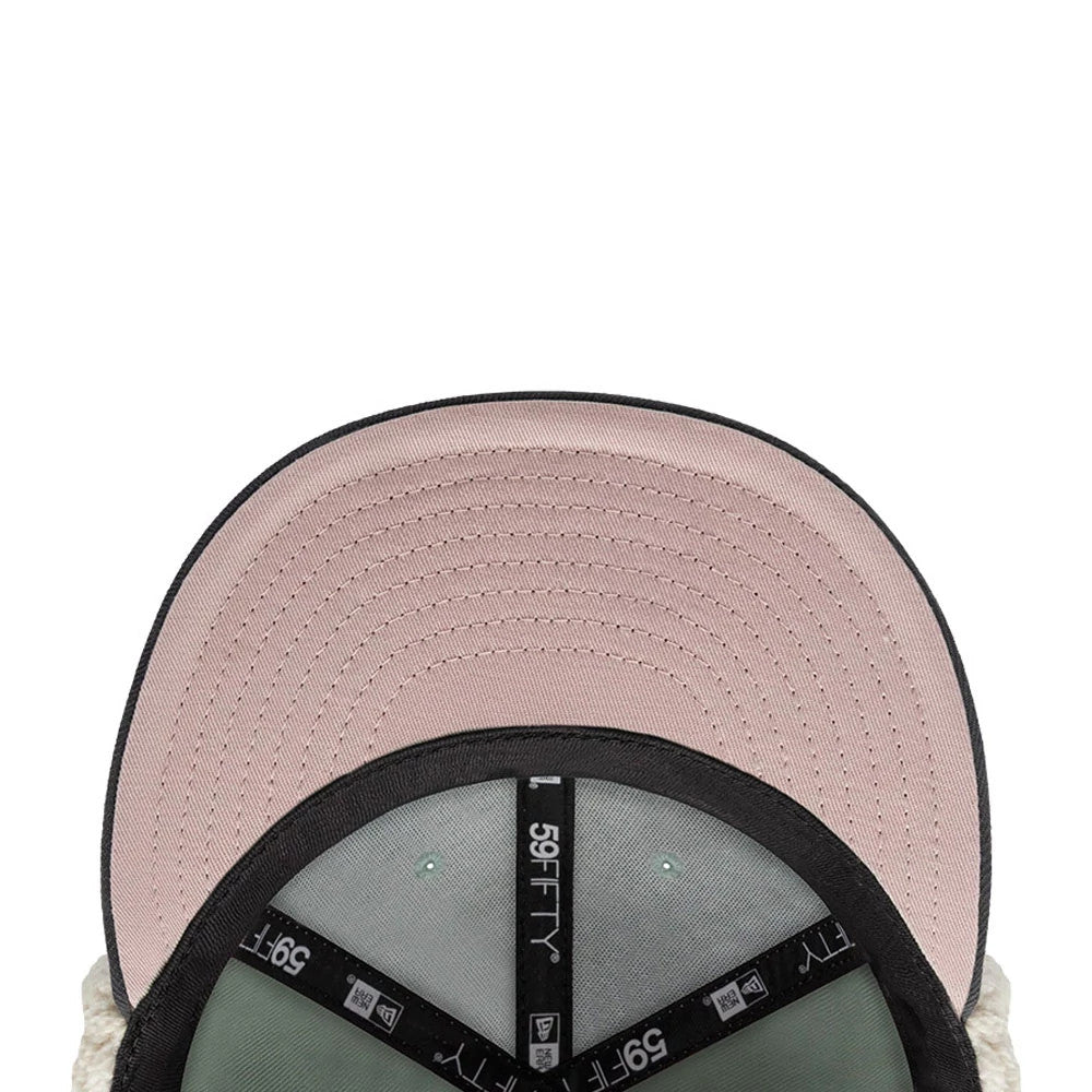 Anaheim Ducks NHL Patch Pastel Green New Era 59FIFTY Fitted Cap, inside view showing the light pink undervisor, black taping with 59FIFTY branding, and a pastel green sweatband lining the structured interior.