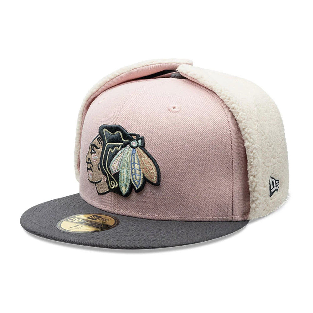 Chicago Blackhawks NHL Patch Pastel Pink New Era 59FIFTY Fitted Cap, three-quarter view showing the raised black and pastel embroidered Blackhawks logo on a structured pastel pink crown, grey visor with a gold 59FIFTY size sticker.