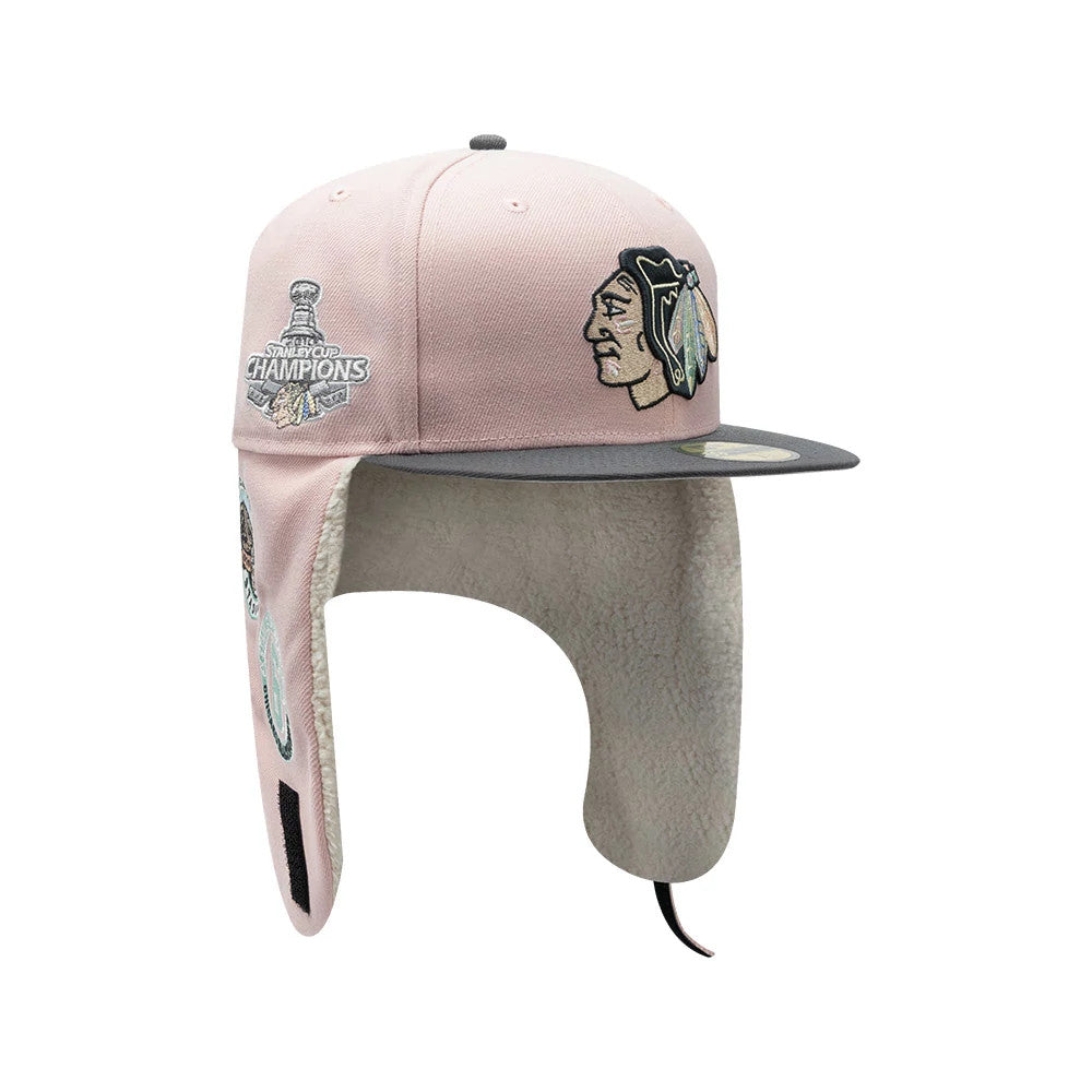 Chicago Blackhawks NHL Patch Pastel Pink New Era 59FIFTY Fitted Cap, three-quarter view showing the raised embroidered Blackhawks logo on the front panel, grey visor with 59FIFTY size sticker, and soft ear flaps with cream lining.