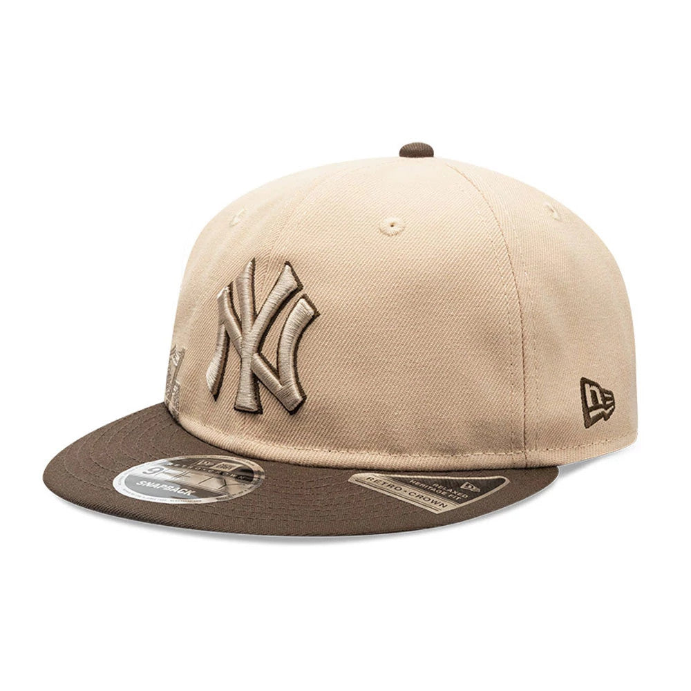 New York Yankees MLB Gothic Script Beige Retro Crown New Era 9FIFTY Cap, three-quarter view showing a brown and beige raised embroidered NY logo on the front panels, brown flat visor with size sticker, and the New Era flag logo on the left side.