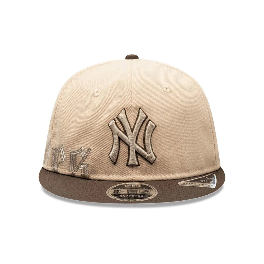 New York Yankees MLB Gothic Script Beige Retro Crown New Era 9FIFTY Cap, front view showing a brown raised embroidered NY logo on the beige crown, accented by additional script details on the left panel.