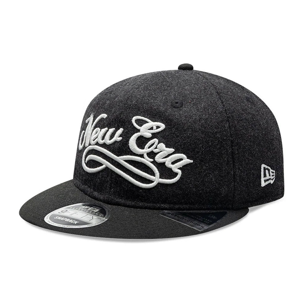 New Era Melton Wool Black Retro Crown 9FIFTY Cap, three-quarter view showing the raised white New Era embroidery on the structured dark grey crown, with a slightly curved black visor and the New Era flag logo embroidered on the left side.