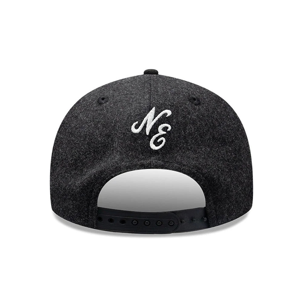 New Era Melton Wool Black Retro Crown 9FIFTY Cap, rear view showing the white embroidered NE logo centred above the adjustable black snapback closure, with a structured black wool crown and matching eyelets for a classic finish.