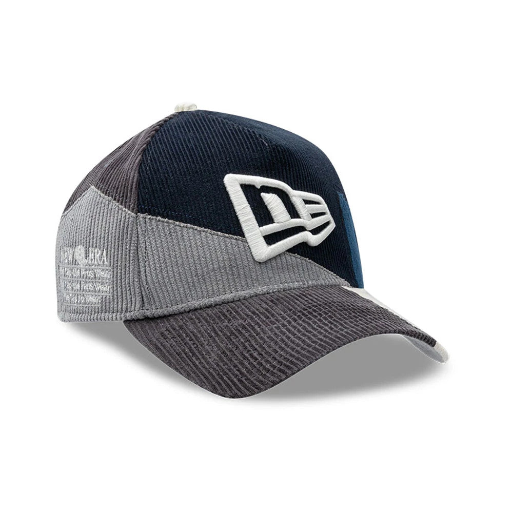 New Era Patchwork Black 9FORTY A-Frame Cap, three-quarter view showing the white raised embroidered New Era logo on the front panel, with distinct grey and black patchwork panels and a grey corduroy-textured curved visor.