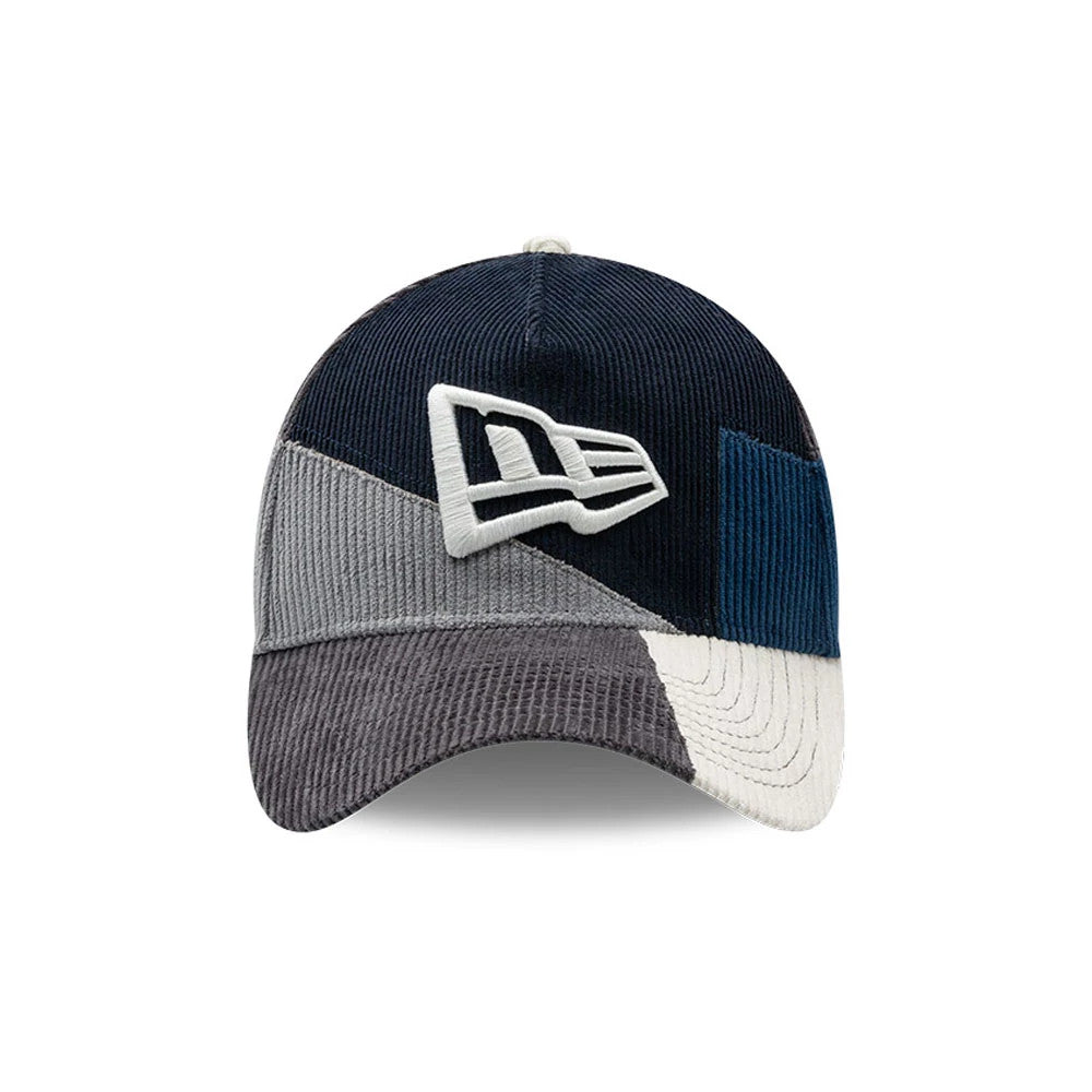 New Era Patchwork Black 9FORTY A-Frame Cap, front view showing a white embroidered New Era flag logo on the front panel, with a patchwork design in navy, grey, and cream corduroy textures, and a curved visor.