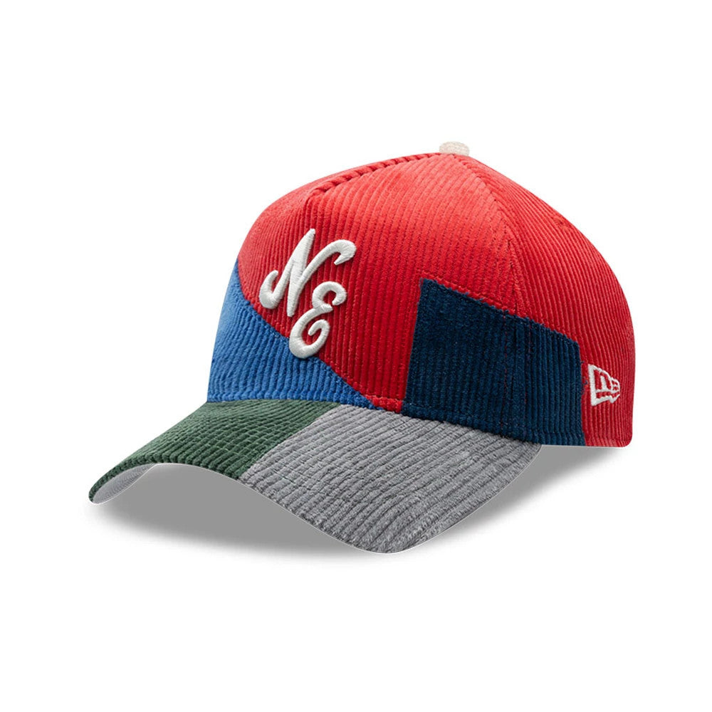 New Era Patchwork Red 9FORTY A-Frame Cap, three-quarter view showing the white embroidered Ne logo on the red panel, the multi-coloured corduroy patchwork of red, blue, green, and grey, and the New Era flag logo on the red left side.
