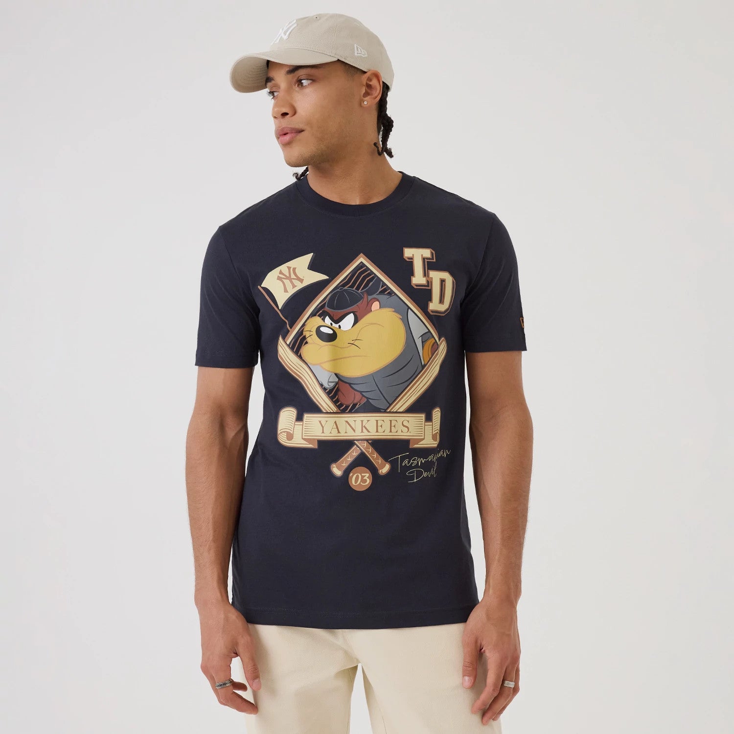 The model is wearing this MLB X Looney Tunes New York Yankees T-Shirt in navy. 1