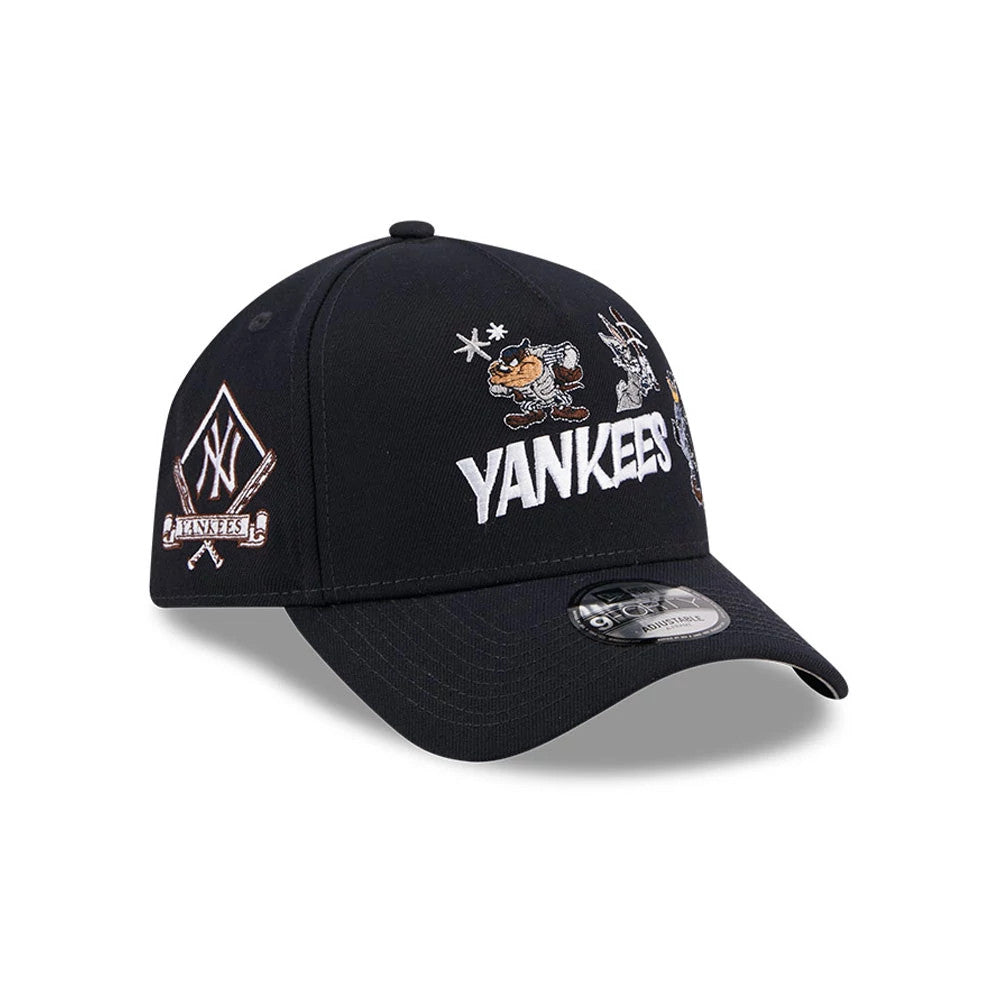 New York Yankees MLB X Looney Tunes Navy New Era 9FORTY A-Frame Adjustable Cap, three-quarter view showing white Yankees lettering and Looney Tunes characters embroidered on the front panel, with an NY logo patch on the left side.