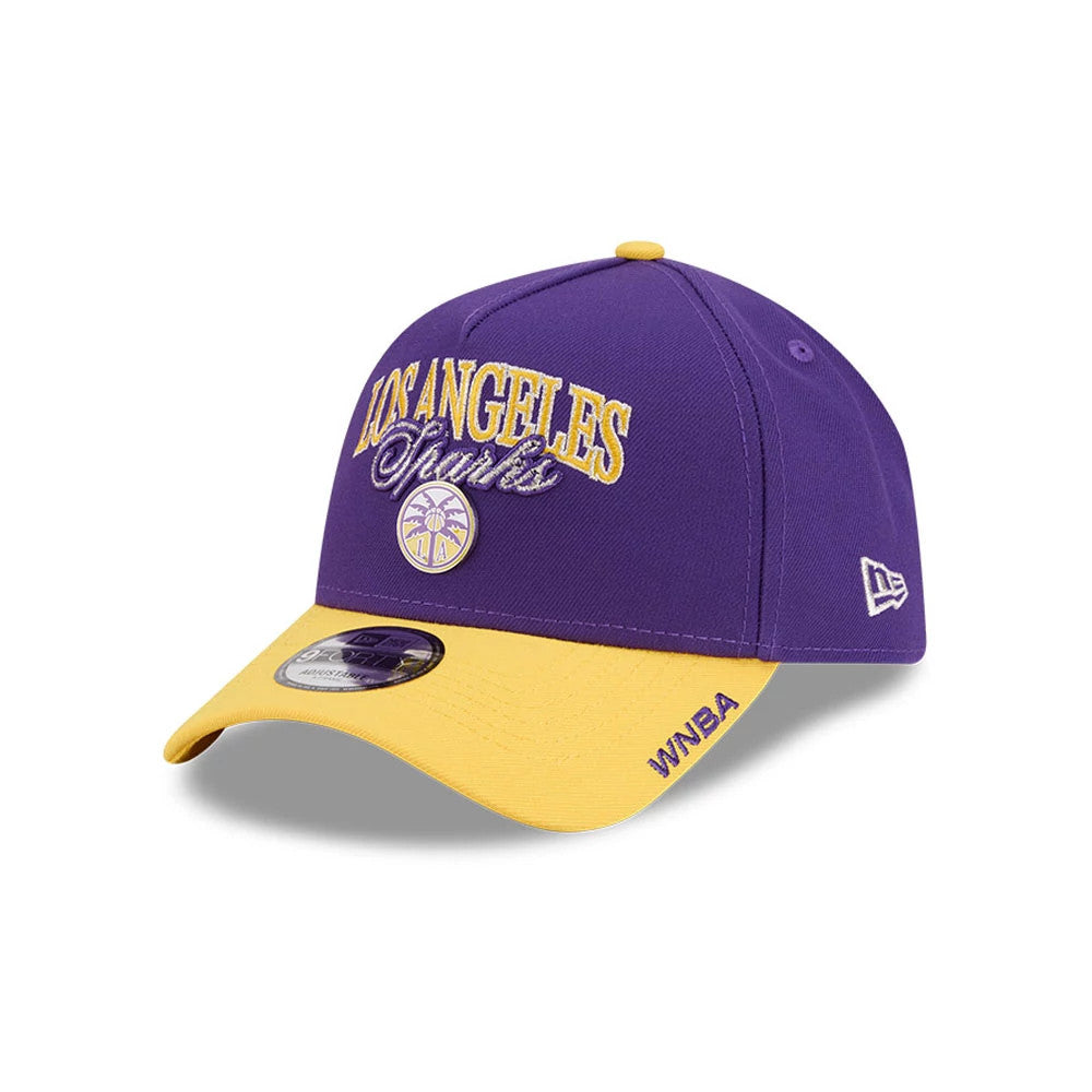 LA Sparks WNBA Tip Off 2026 Purple New Era 9FORTY A-Frame Adjustable Cap, three-quarter view showing the yellow embroidered Los Angeles Sparks lettering and logo on the front panel, yellow visor with a 9FORTY size sticker, and WNBA text on the edge.