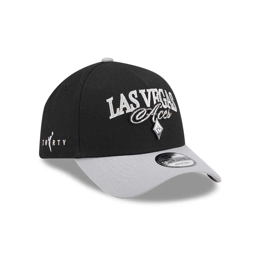 Las Vegas Aces WNBA Tip Off 2026 Black New Era 9FORTY A-Frame Adjustable Cap, three-quarter view showing raised white embroidery of the Las Vegas Aces logo on the front panel, a grey visor with a 9FORTY size sticker, and side detail logo.
