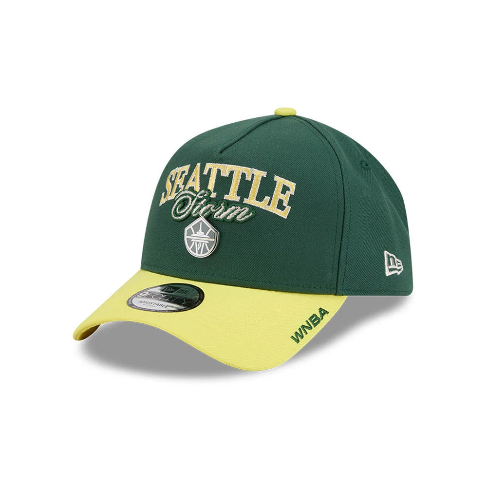 Seattle Storm WNBA Tip Off 2026 Dark Green New Era 9FORTY A-Frame Adjustable Cap, three-quarter view showing the raised embroidered Seattle Storm logo on the front panel, yellow curved visor with WNBA text, and New Era flag logo on the left side.