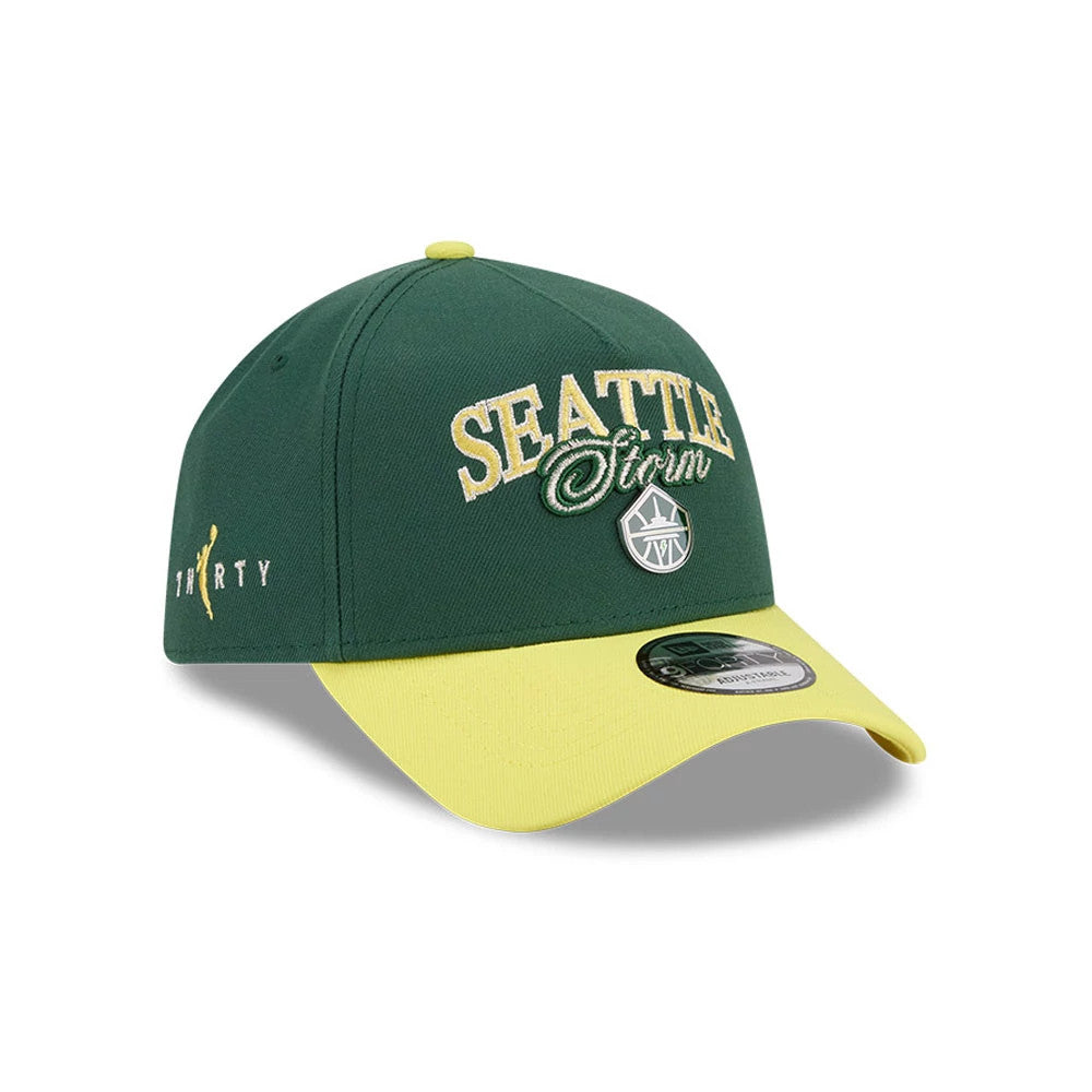 Seattle Storm WNBA Tip Off 2026 Dark Green New Era 9FORTY A-Frame Adjustable Cap, three-quarter view showing the raised yellow and green Seattle Storm embroidery on the front panel, yellow curved visor and a 9FORTY size sticker on top.