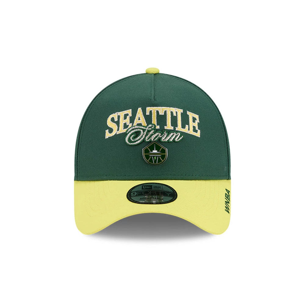 Seattle Storm WNBA Tip Off 2026 Dark Green New Era 9FORTY A-Frame Adjustable Cap, front view showing raised embroidered Seattle Storm logo in white and green on the dark green front panel, with a contrasting yellow curved visor.