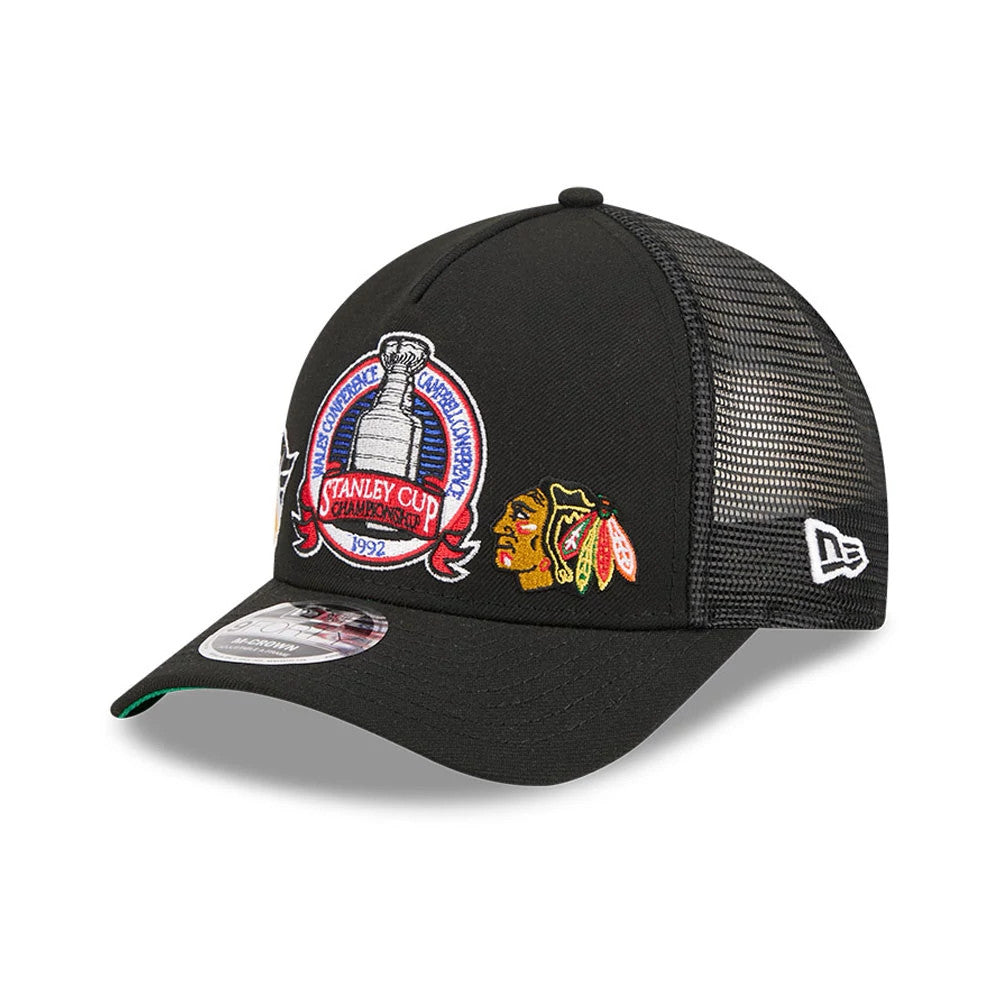 Penguins NHL Stanley Cup Black New Era 9FORTY M-Crown A-Frame Trucker Adjustable Cap, three-quarter view showing the large embroidered Stanley Cup logo on the front panel, with a red centre and black visor featuring a 9FORTY size sticker.