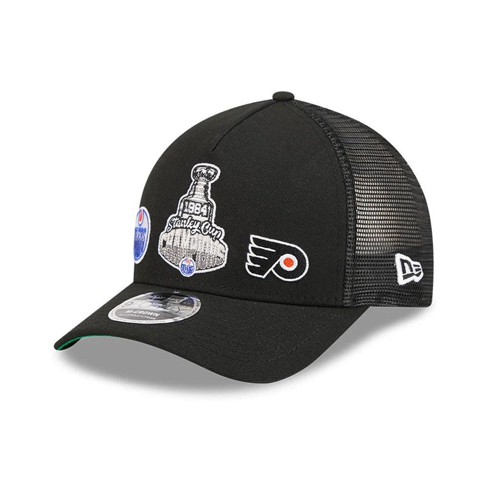 Oilers NHL Stanley Cup Black New Era 9FORTY M-Crown A-Frame Trucker Adjustable Cap, three-quarter view showing 1984 Stanley Cup embroidered graphic on front panel, mesh rear panels, curved black visor with green undervisor.
