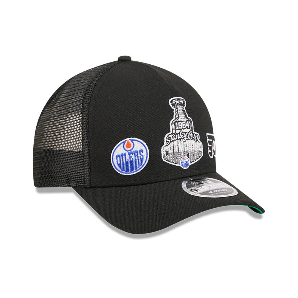 Oilers NHL Stanley Cup Black New Era 9FORTY M-Crown A-Frame Trucker Adjustable Cap, three-quarter view showing raised embroidered 1984 Stanley Cup and Oilers logos on the black front panel, mesh rear, and a 9FORTY size sticker on the curved visor.