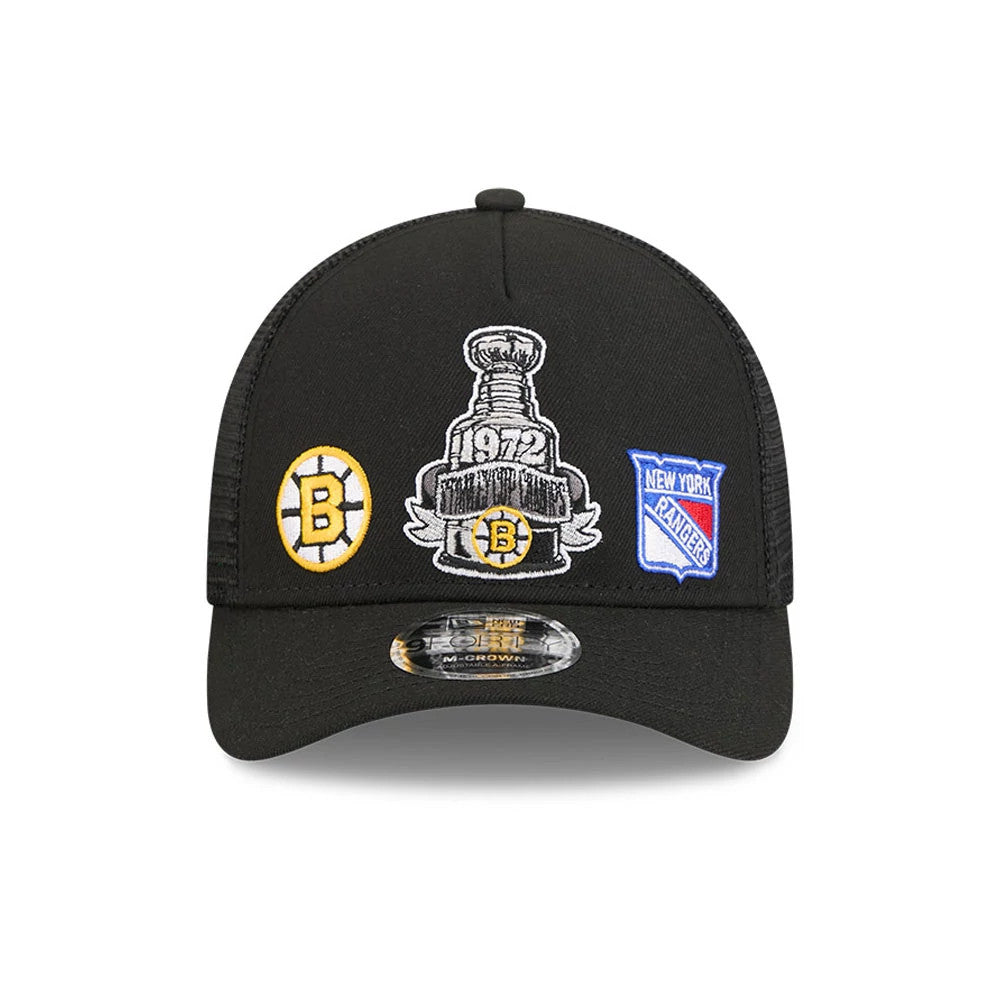 Bruins NHL Stanley Cup Black New Era 9FORTY M-Crown A-Frame Trucker Adjustable Cap, front view showing a large central embroidered Stanley Cup graphic flanked by Bruins and Rangers logos, with a black curved visor and 9FORTY size sticker.