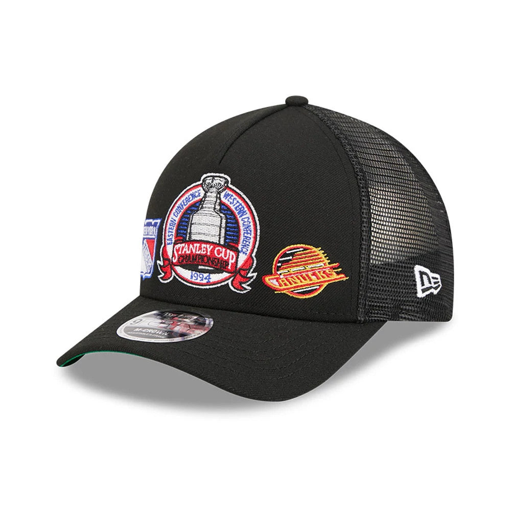 Rangers NHL Stanley Cup Black New Era 9FORTY M-Crown A-Frame Trucker Adjustable Cap, three-quarter view showing a detailed embroidered Stanley Cup Championship logo on the front panel, black mesh rear panels, and New Era flag logo on the left side.