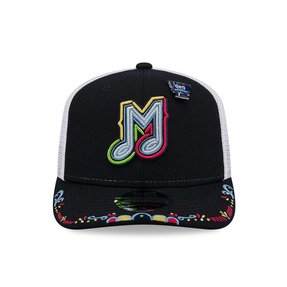 Memphis Redbirds MiLB La Copa 2026 Navy New Era 9SEVENTY Stretch Snap Adjustable Cap, front view showing the colourful embroidered M logo on the black front panel, a La Copa pin on the right, and decorative patterns on the visor.