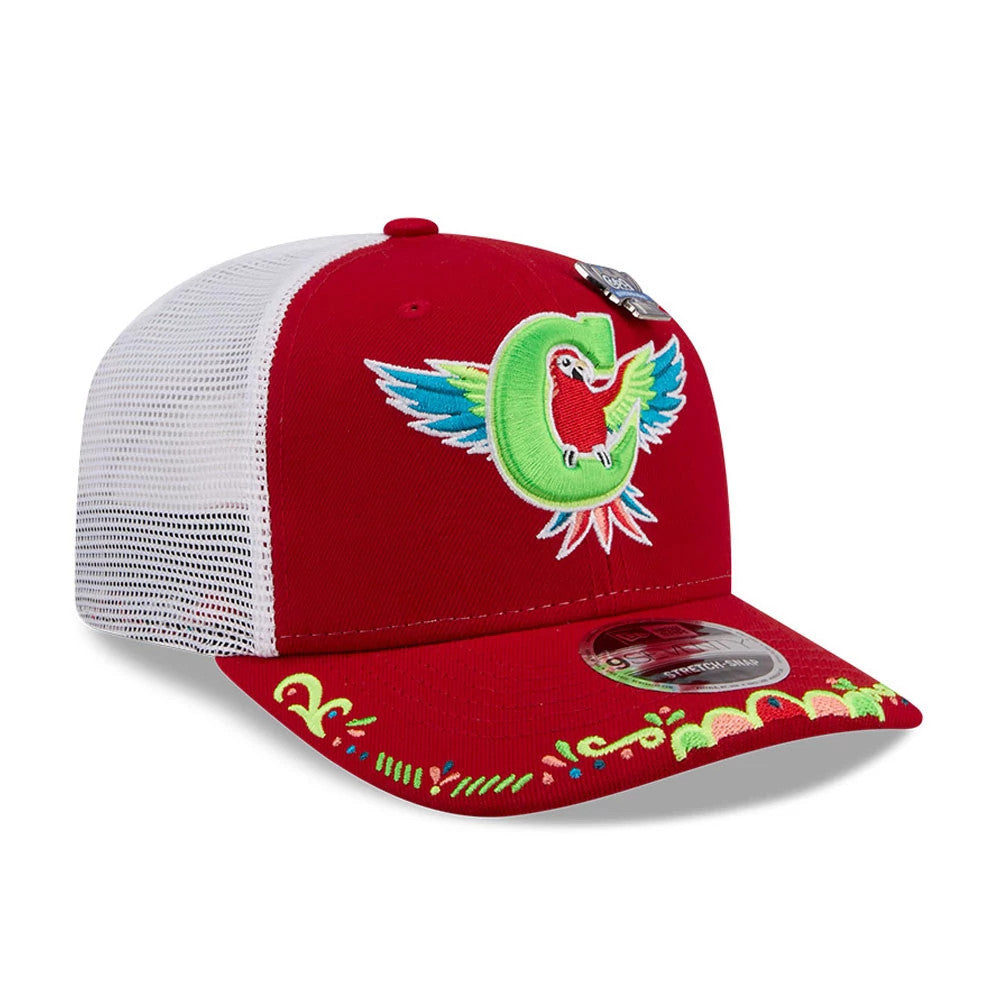 Charlotte Knights MiLB La Copa 2026 Red New Era 9SEVENTY Stretch Snap Adjustable Cap, three-quarter view showing a embroidered parrot and C logo on the front panel, intricate colourful designs on the red visor, and a 9SEVENTY size sticker.