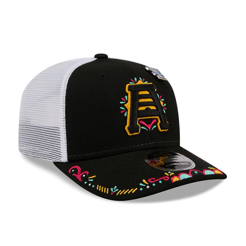SLC Bee MiLB La Copa 2026 Black New Era 9SEVENTY Stretch Snap Adjustable Cap, three-quarter view showing a yellow embroidered A logo with colourful surrounding patterns on the front black panel, a white mesh back.