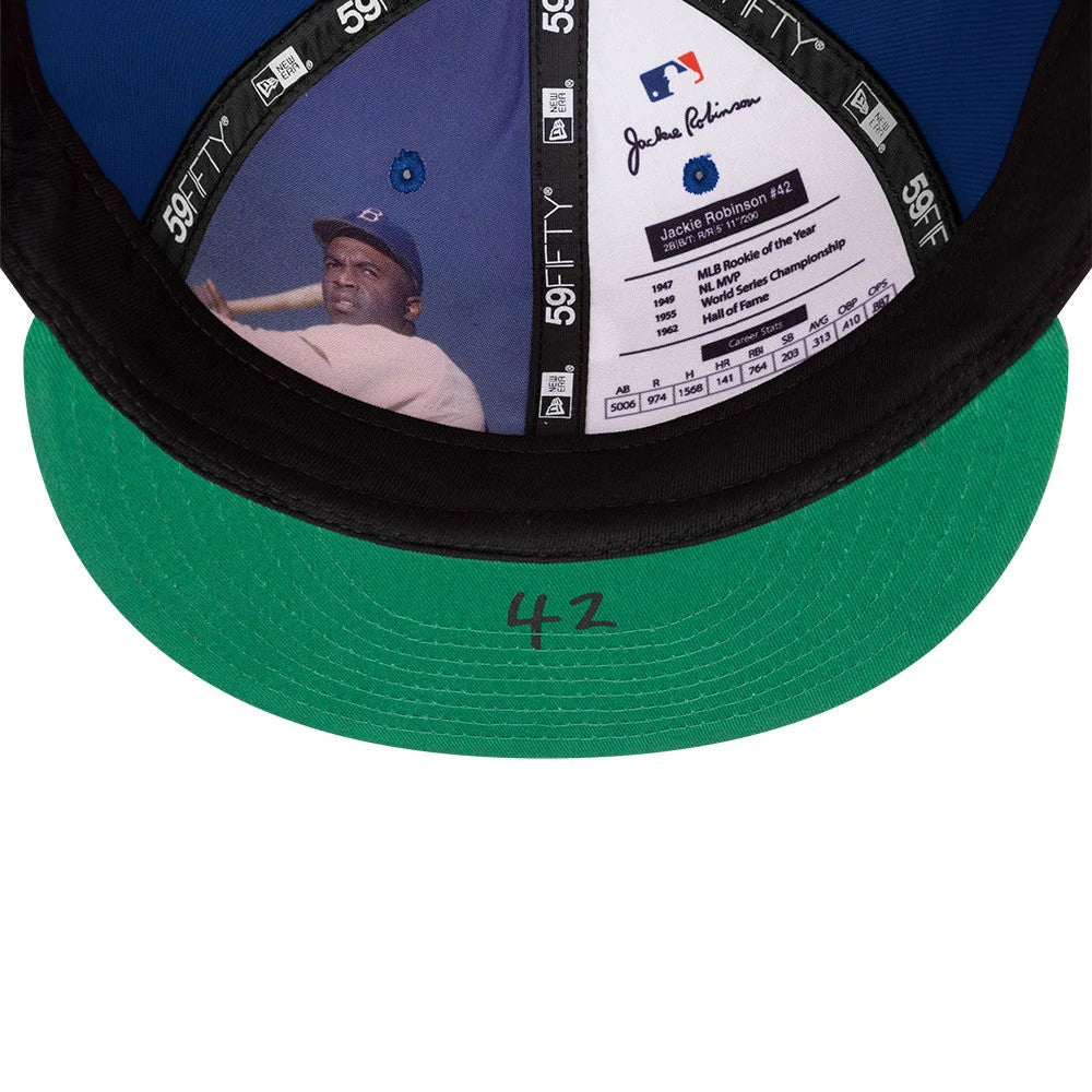 New York Mets MLB Jackie Robinson Blue New Era 59FIFTY Fitted Cap, inside view showing Jackie Robinson imagery and achievements on crown panels, with blue taping, a green undervisor featuring the number 42, and black sweatband detail.
