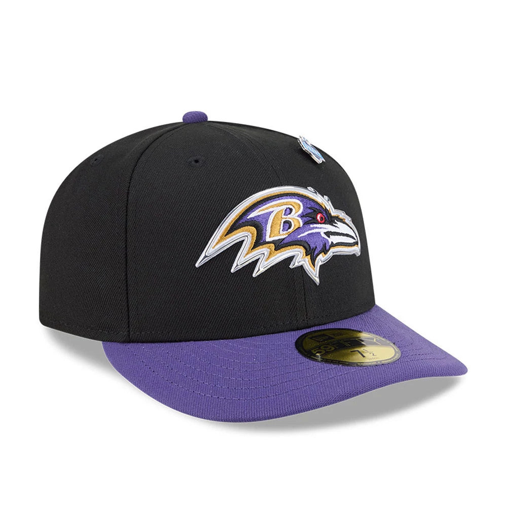 Baltimore Ravens NFL Draft 2026 Black New Era 59FIFTY Fitted Cap, three-quarter view showing the raised embroidered Ravens logo on the front panel, contrasting purple visor, and gold 59FIFTY size sticker on the purple undervisor.