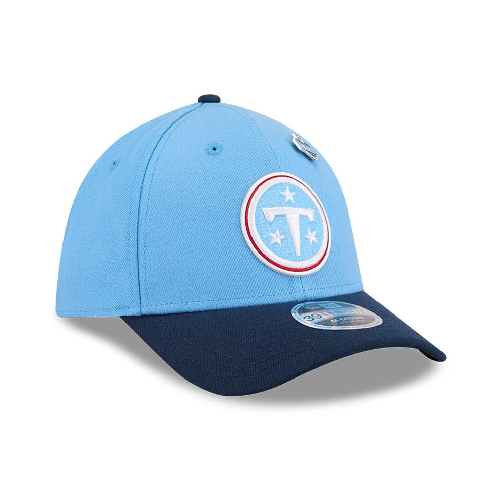 Tennessee Titans NFL Draft 2026 Dark Blue New Era 39THIRTY M-Crown Stretch Fit Cap, three-quarter view showing a prominently embroidered white and red Titans logo on the light blue front panel, with a contrasting dark blue curved visor.