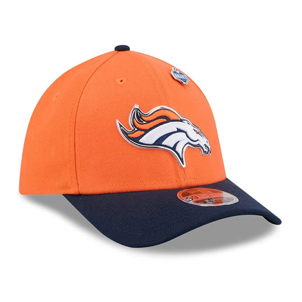 Broncos NFL Draft 2026 Orange New Era 39THIRTY M-Crown Stretch Fit Cap, front view showing the raised embroidered Broncos logo on the orange front panel, a contrasting dark navy visor with a 39THIRTY size sticker, and an NFL Draft pin on the crown.
