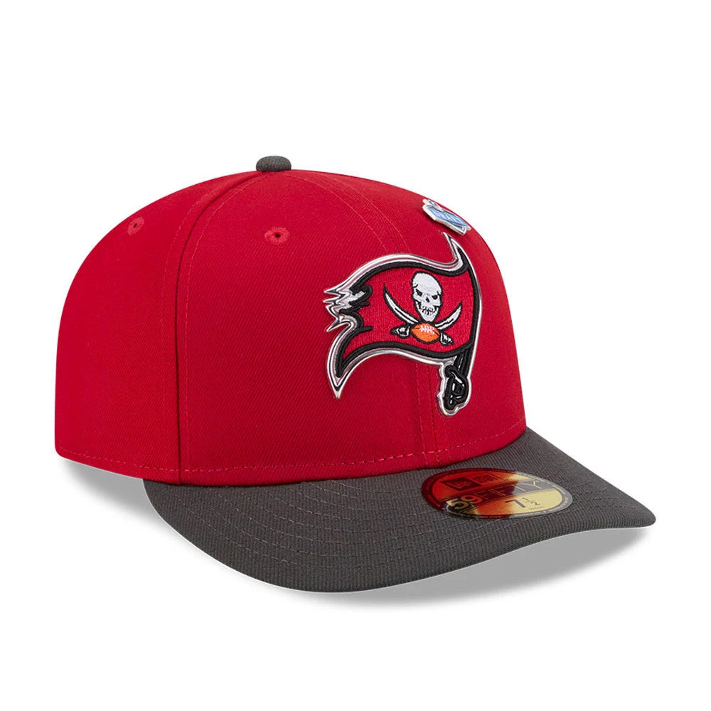 Tampa Bay Buccaneers NFL Draft 2026 Red New Era 59FIFTY Fitted Cap, three-quarter view showing a raised embroidered Buccaneers logo on the front red panel, featuring a contrasting grey flat visor and a gold 59FIFTY size sticker on the visor.