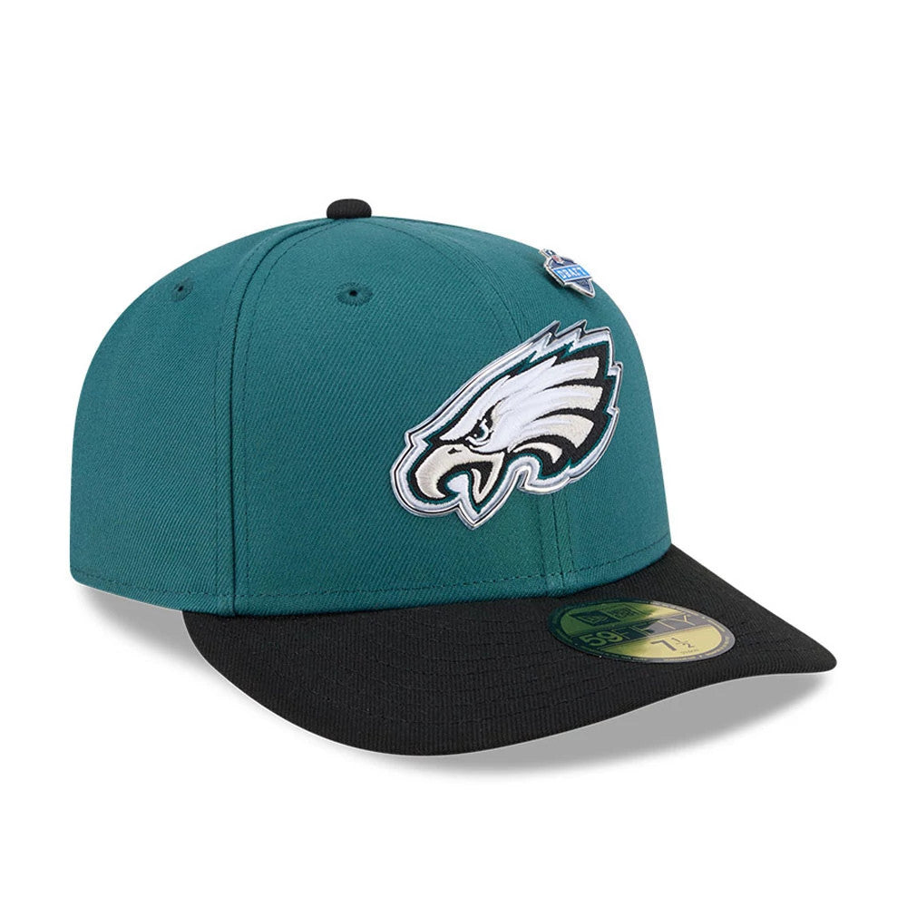 Philadelphia Eagles NFL Draft 2026 Dark Green New Era 59FIFTY Fitted Cap, three-quarter view showing the raised embroidered Eagles logo on the front panel, paired with a black flat visor and a gold 59FIFTY size sticker.