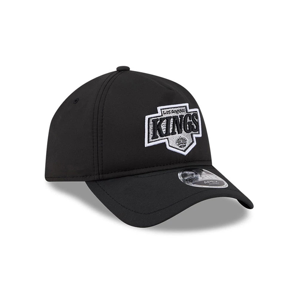 Los Angeles Kings NHL Quickstrike Black New Era 9FORTY Apex Adjustable Cap, three-quarter view showing a raised white and silver embroidered Kings logo on the front panel, black curved visor, and a 9FORTY size sticker on the visor.
