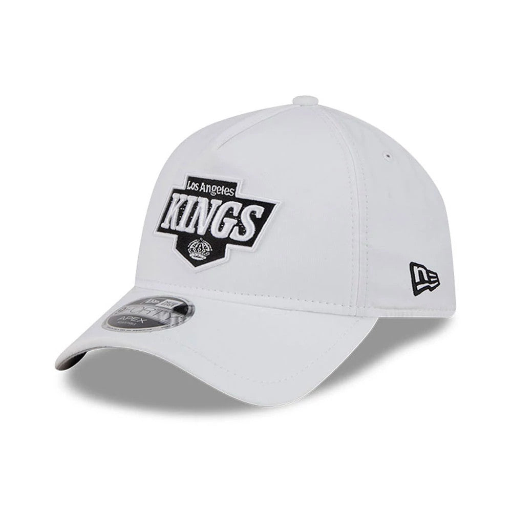 LA Kings NHL Quickstrike White New Era 9FORTY Apex Adjustable Cap, three-quarter view showing the raised embroidered black and white Kings logo on the front panel, a curved visor with a 9FORTY size sticker.