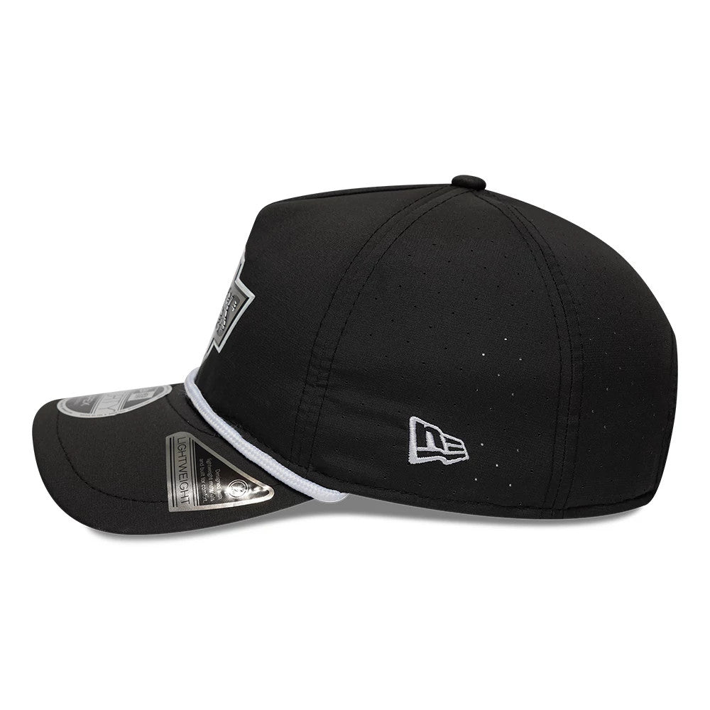 LA Kings NHL Quickstrike Black New Era 9FORTY Apex Adjustable Cap, side view featuring the white embroidered New Era flag logo on the left side, a structured black crown with perforations, and a curved black visor with a 9FORTY size sticker.