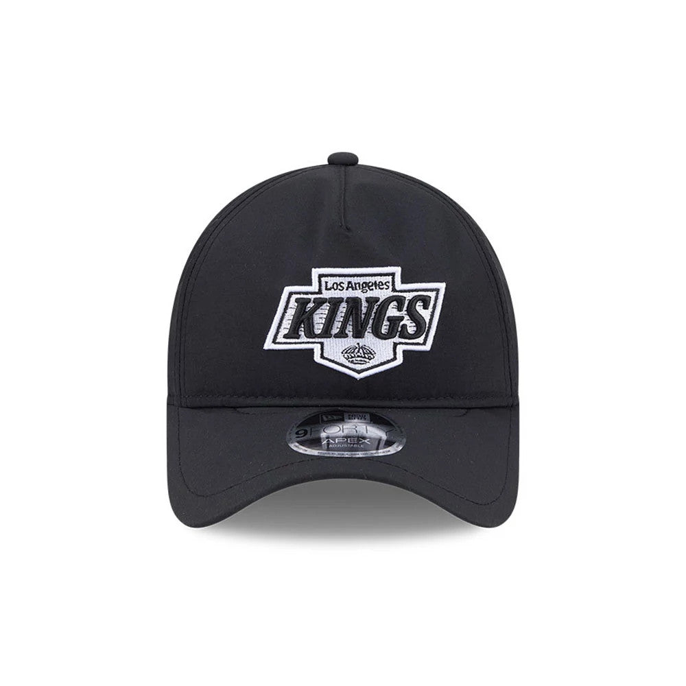 Kings NHL Quickstrike Black New Era 9FORTY Apex Adjustable Cap, front view showing the raised embroidered Los Angeles Kings logo in black and white on the structured black crown, with a curved visor and 9FORTY size sticker on the visor.