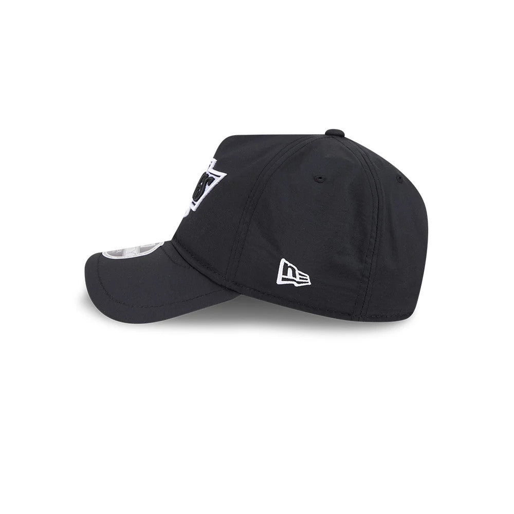 Kings NHL Quickstrike Black New Era 9FORTY Apex Adjustable Cap, side view showing the white embroidered New Era flag logo on the left side of the black structured crown, curved visor and front panel logo embroidery.
