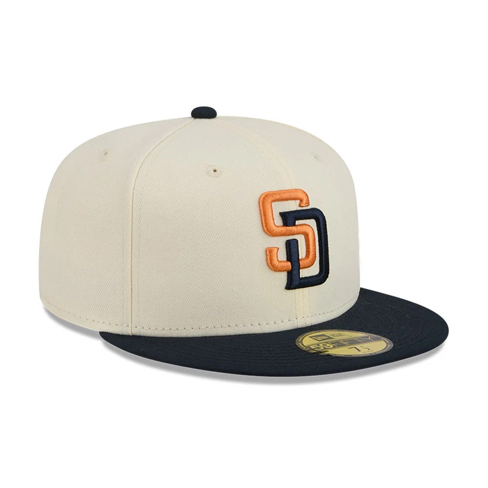 San Diego Padres MLB City Connect Cream New Era 59FIFTY Fitted Cap, three-quarter view showing raised orange and navy SD front logo, black flat visor with gold 59FIFTY size sticker, and black top button.