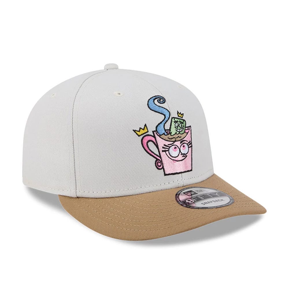 Nickelodeon Fairly Oddparents Light Beige New Era 9FIFTY Snapback Adjustable Cap, front view showing a colourful embroidered pink teacup graphic with crown details on the structured light beige crown, contrasted by a beige flat visor.