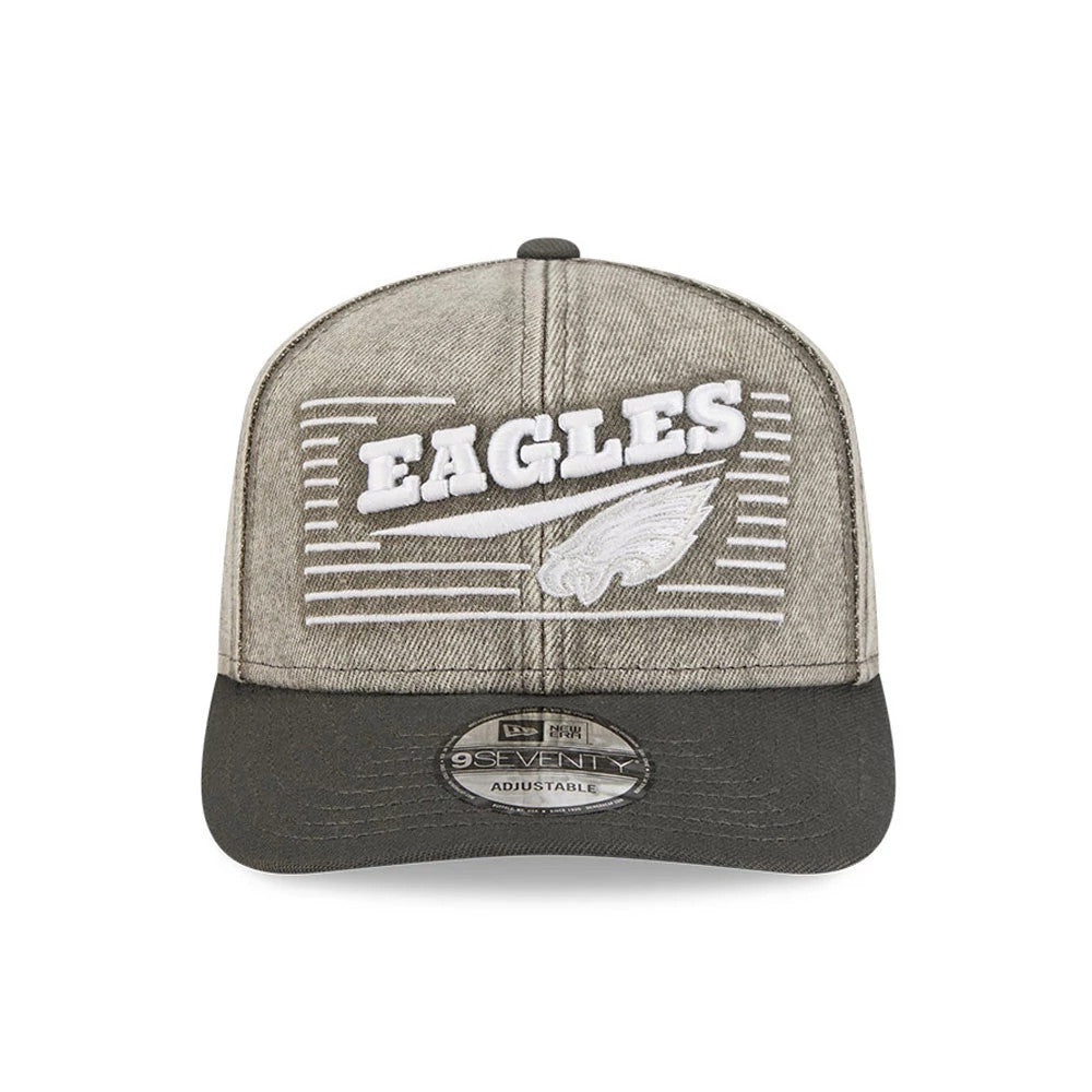 Philadelphia Eagles NFL Washed Denim Dark Grey New Era 9SEVENTY Stretch Snap Cap, front view showing the white embroidered Eagles wordmark and logo on the washed denim crown, with a dark grey curved visor and a 9SEVENTY size sticker on the visor.