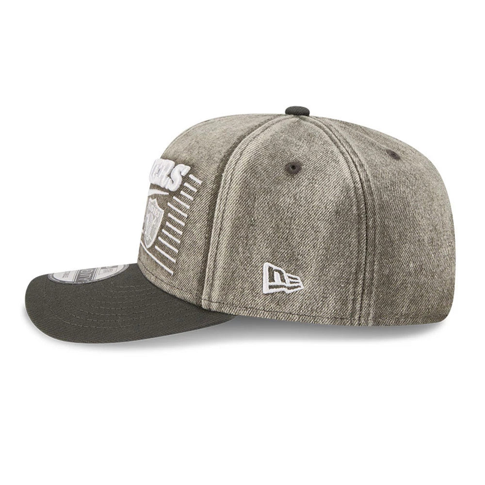 Las Vegas Raiders NFL Washed Denim Dark Grey New Era 9SEVENTY Stretch Snap Cap, side view showing the white New Era flag logo on the left side, embroidered Raiders lettering on the front panel.